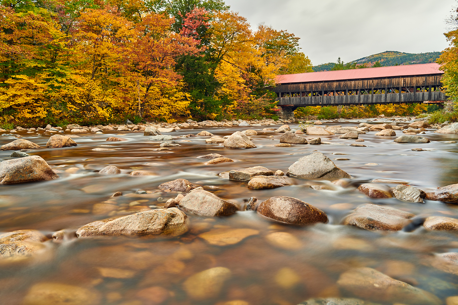 Swift River and old covered Albany Bridge at autumn in White Mountain National Forest, New Hampshire, USA. Fall in New England.