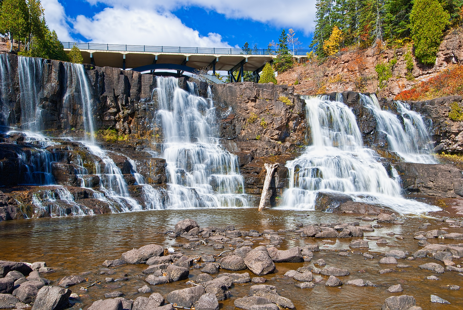 highway 61 over middle gooseberry falls which is one of a number of falls on the gooseberry river that eventually enters into lake superior.
