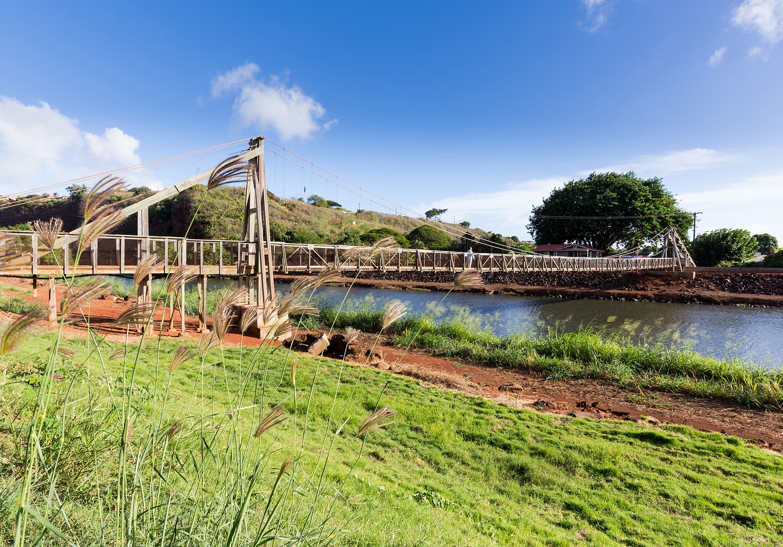 Wide angle view of the famous wooden suspension swinging bridge to cross the river in Hanapepe Kauai.