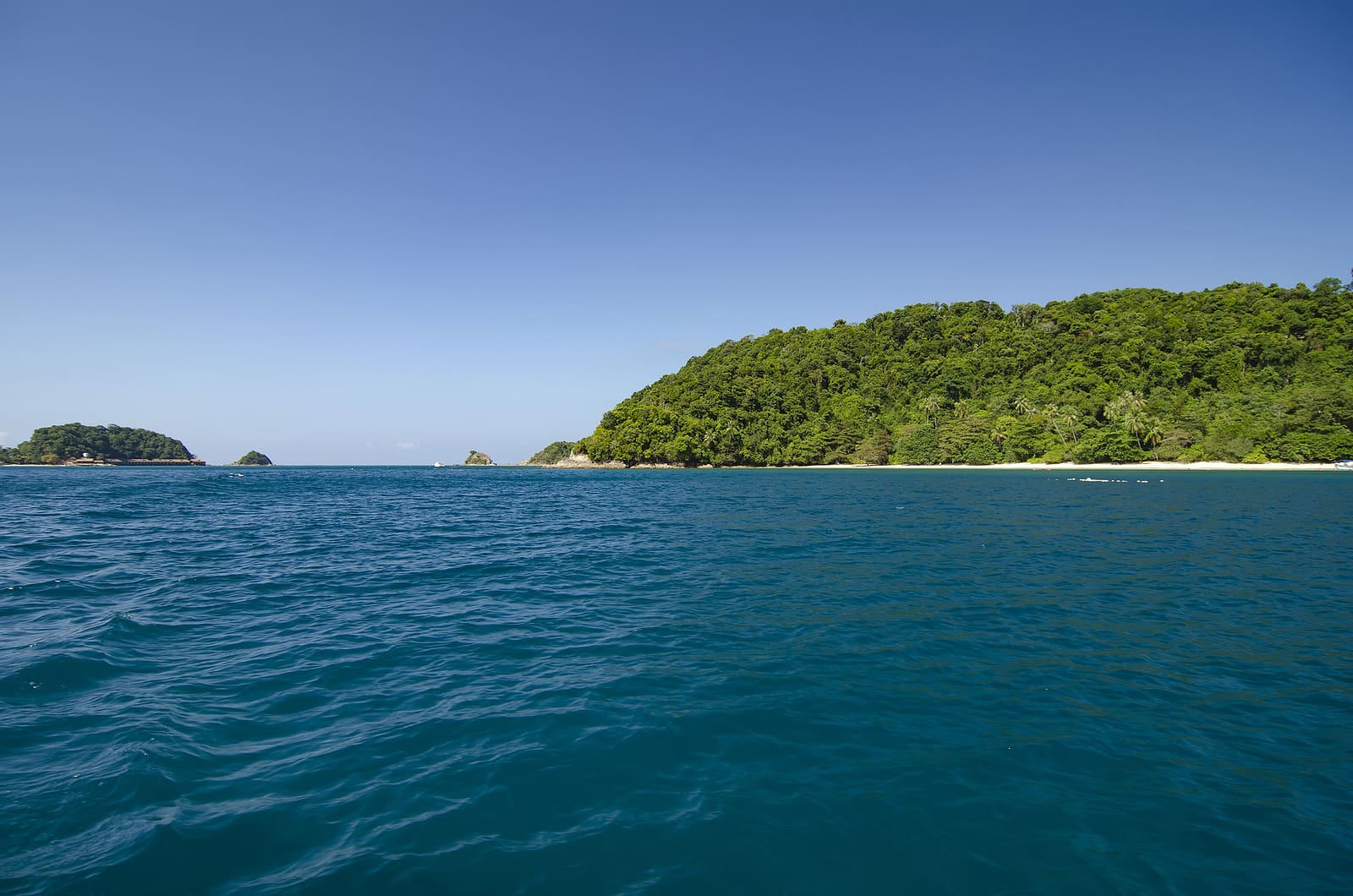 scenic sea view of the Kapas Island at Terengganu, Malaysia. Clear sea water and blue sky background. Rocky island and cloudy sky at sunny day.image taken at Kapas Island (Cotton Island), Malaysia