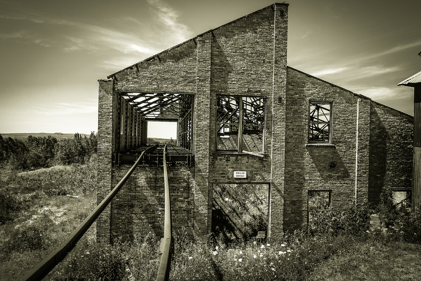 Abandoned Quincy Mine In Michigan. Railroad tracks through an abandoned building at the Quincy copper mine in Calumet, Michigan. The mine is part of Keweenaw National Historic Park in Michigan's Upper Peninsula.