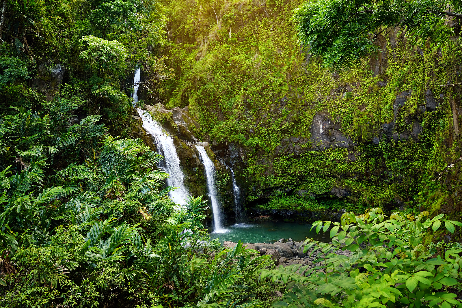 Upper Waikani Falls also known as Three Bears a trio of large waterfalls amid rocks & lush vegetation with a popular swimming hole off the Road to Hana Highway Maui Hawaii USA